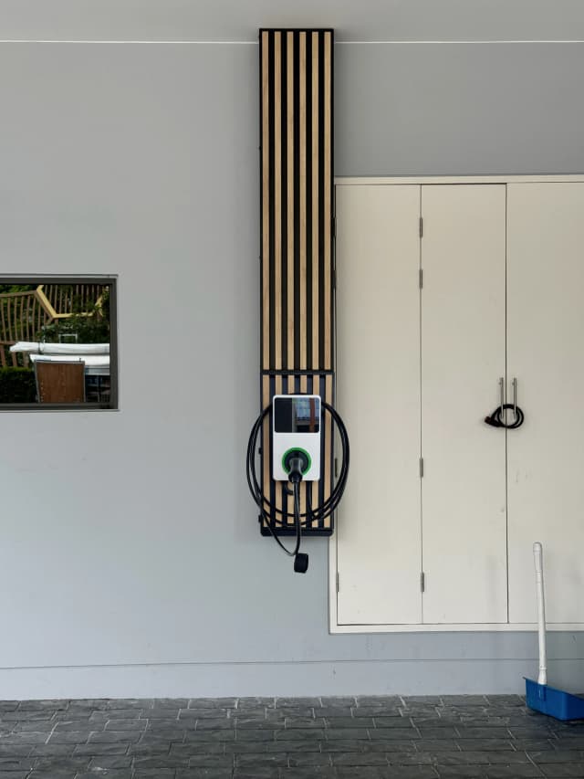 ผลงานติดตั้ง Autel MaxiCharger 7.4kW สีเงิน พร้อมแท่นอลูมิเนียมลายไม้ ระแนงสีน้ำตาลอ่อน เข้ากับตัวบ้าน โดย Auintech